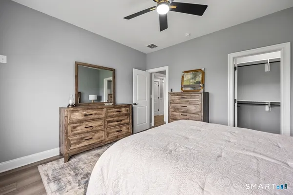 a bedroom with a bed and a dresser
