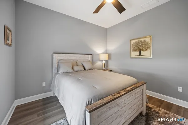 a bedroom with a bed and a wall painting