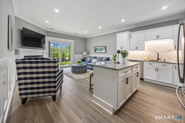 a kitchen with kitchen island a sink stove and cabinets