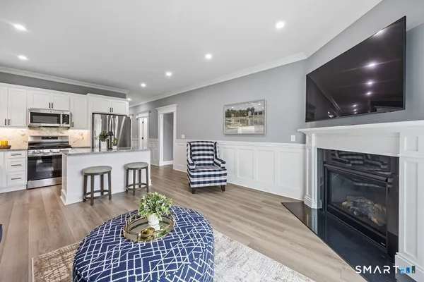 a living room with furniture a flat screen tv and a fireplace