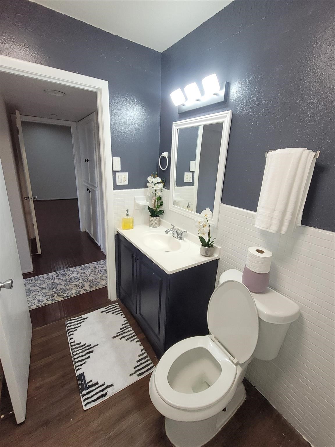 7213 Beechnut Street Houston, TX 77074 - Photo 4 of 12 a bathroom with a double vanity sink and a mirror