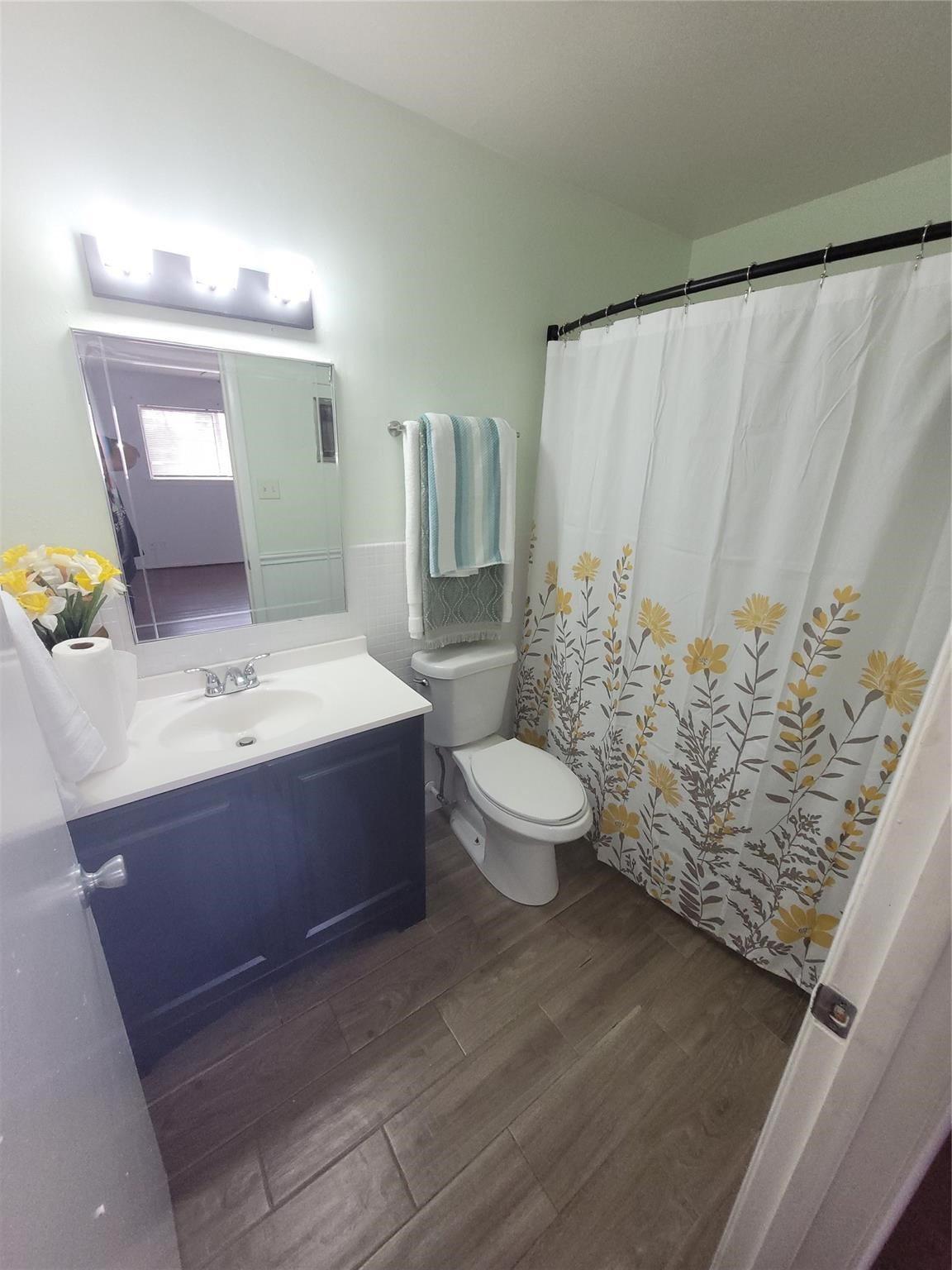 7213 Beechnut Street Houston, TX 77074 - Photo 8 of 12 a bathroom with a sink a toilet and mirror