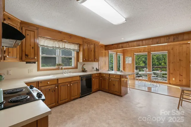 a kitchen with stainless steel appliances granite countertop a sink and cabinets