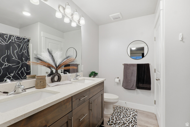 2011 Wren Circle Logan, UT 84339 - Photo 15 of 20 Primary bathroom featuring double vanity, a shower / tub combo with light wood-style floors