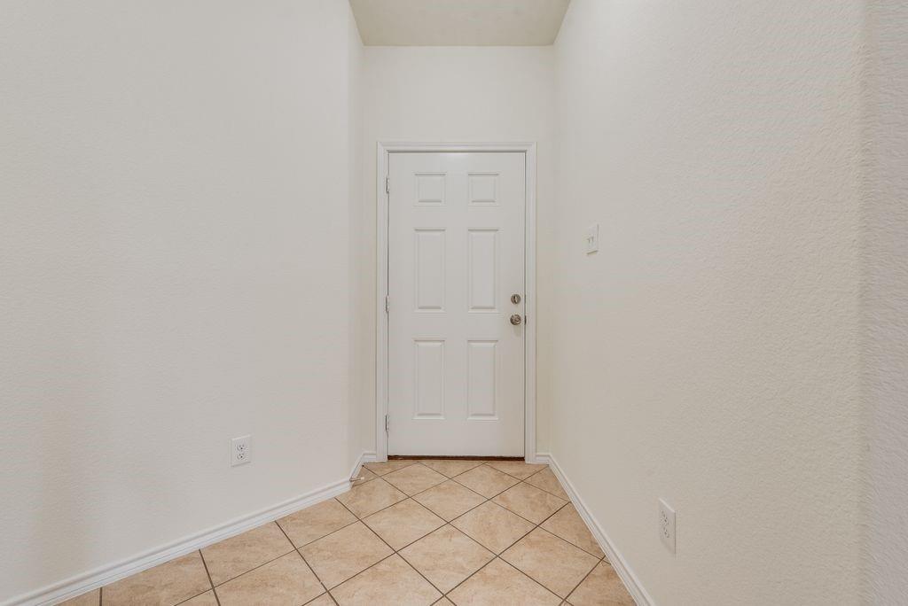 5117 Grayson Ridge Drive Fort Worth, TX 76179 - Photo 14 of 31 Doorway with tile flooring and baseboards