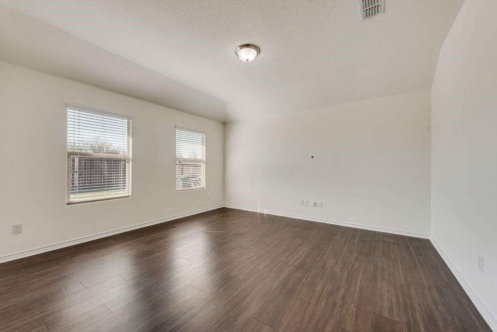 5117 Grayson Ridge Drive Fort Worth, TX 76179 - Photo 16 of 36 an empty room with wooden floor and windows