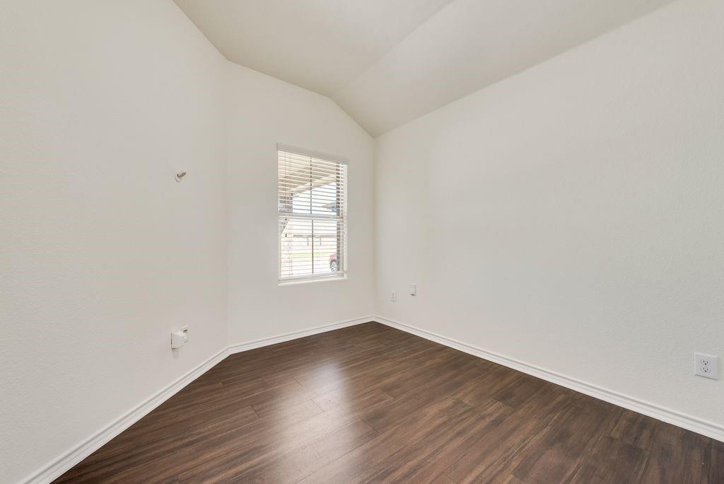 5117 Grayson Ridge Drive Fort Worth, TX 76179 - Photo 21 of 36 an empty room with wooden floor and windows