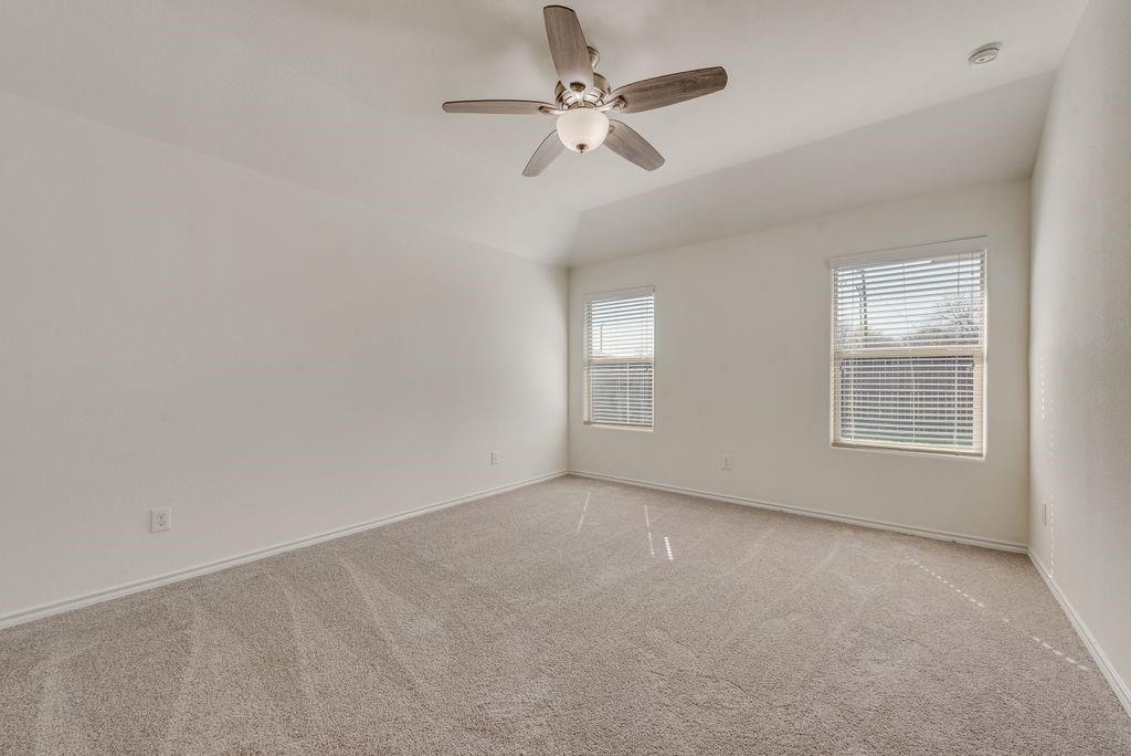 5117 Grayson Ridge Drive Fort Worth, TX 76179 - Photo 23 of 36 an empty room with windows and fan