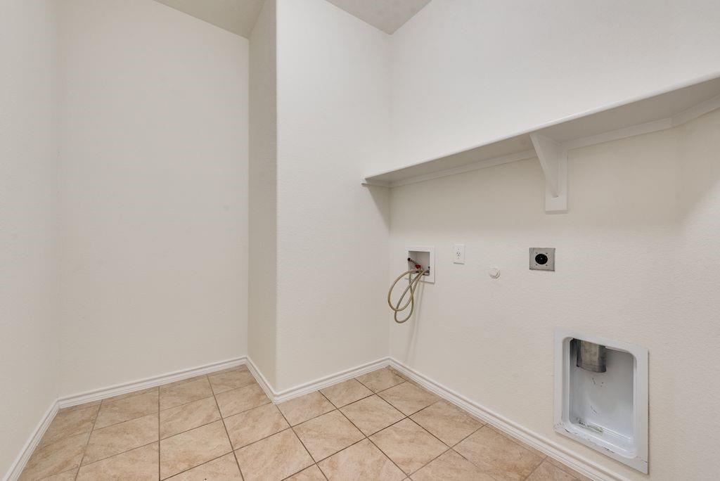 5117 Grayson Ridge Drive Fort Worth, TX 76179 - Photo 23 of 31 Laundry area with full size washer and dryer hookup, tile floors and extra space