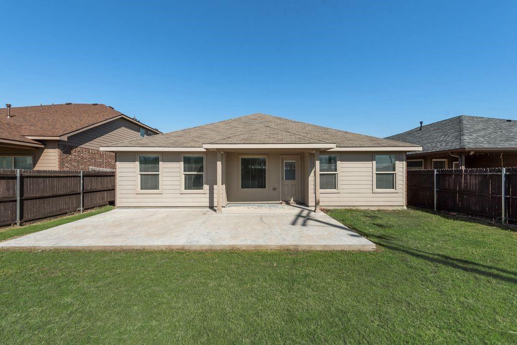 5117 Grayson Ridge Drive Fort Worth, TX 76179 - Photo 27 of 31 Back of property featuring a covered extended patio area, a fenced backyard, and roof with shingles