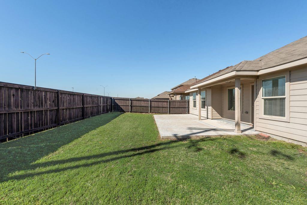 5117 Grayson Ridge Drive Fort Worth, TX 76179 - Photo 28 of 31 Fenced backyard with a covered extended patio area