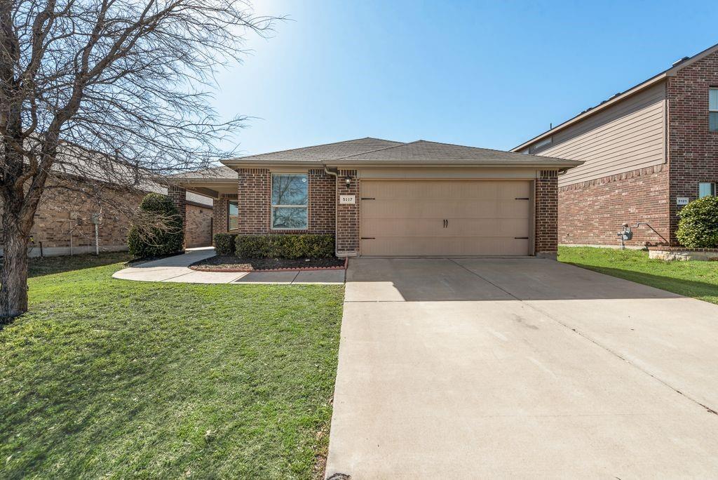 5117 Grayson Ridge Drive Fort Worth, TX 76179 - Photo 31 of 31 Single story home with an attached garage, a front lawn, concrete driveway, brick siding, and a shingled roof