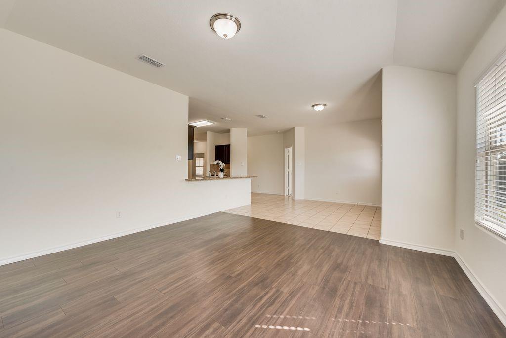 5117 Grayson Ridge Drive Fort Worth, TX 76179 - Photo 8 of 31 Unfurnished room with dark wood-style flooring and baseboards