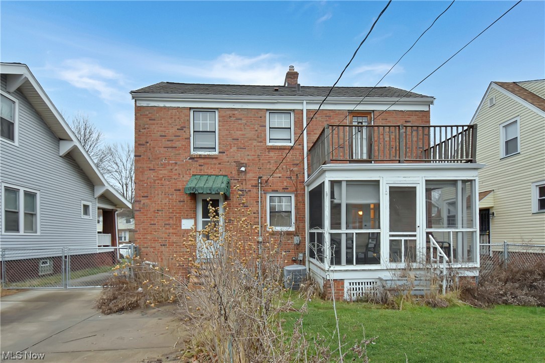 1068 Rushleigh Road Cleveland Heights, OH 44121 - Photo 21 of 22 Back of house with a yard, central air condition unit, a sunroom, and a balcony