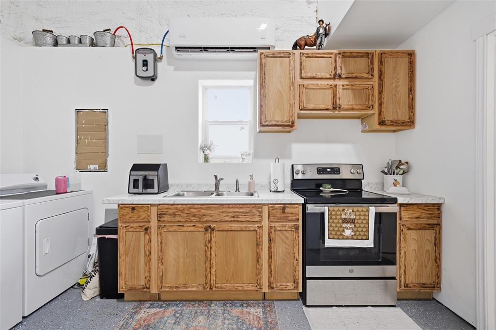 151 Kasberg Road Leroy, TX 76691 - Photo 28 of 40 a kitchen with cabinets a sink and appliances