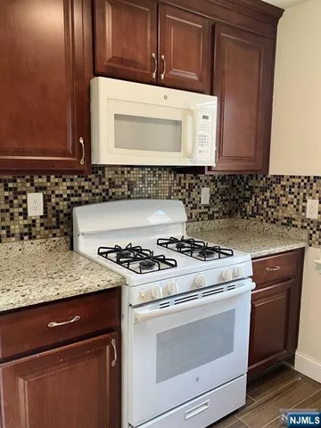 a stove top oven sitting inside of a kitchen