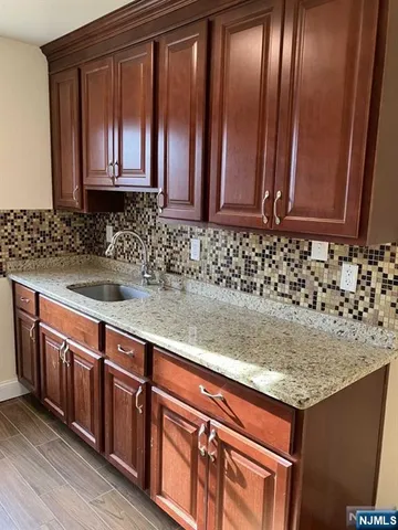 a kitchen with stainless steel appliances granite countertop wooden cabinets a sink and dishwasher
