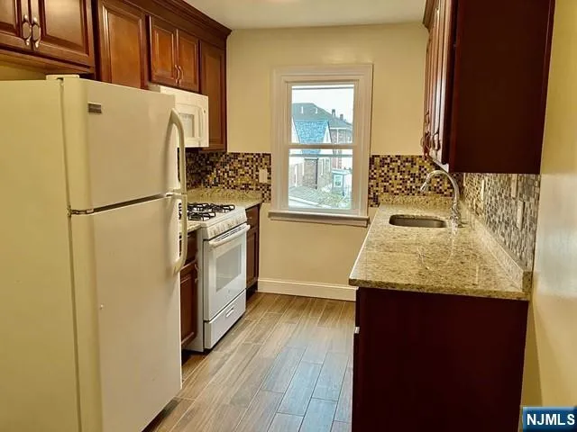 a white refrigerator freezer sitting inside of a kitchen