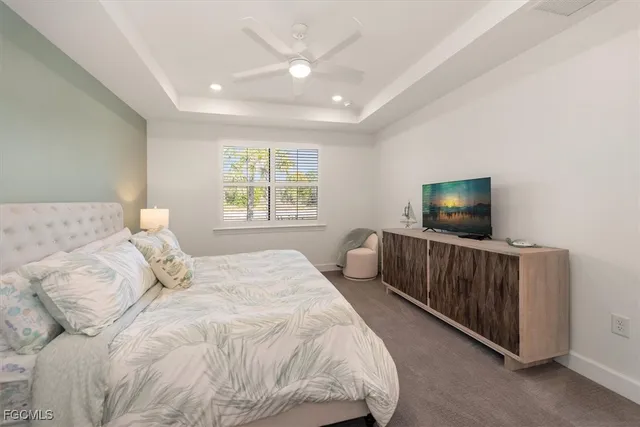 a bedroom with a bed and a television