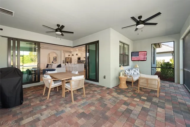 a dining room with furniture a rug and a large window