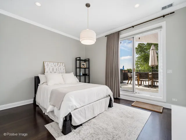 a bedroom with a large bed and a large window