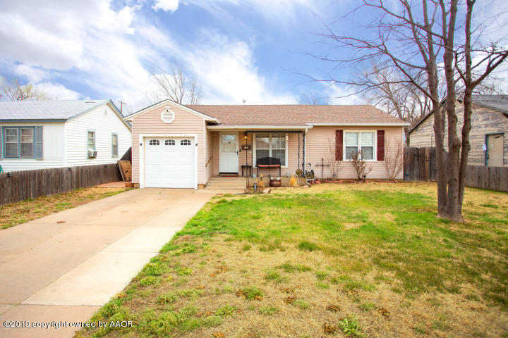 4013 South Travis Street Amarillo, TX 79110 - Photo 2 of 40 a view of a house with a backyard and a tree