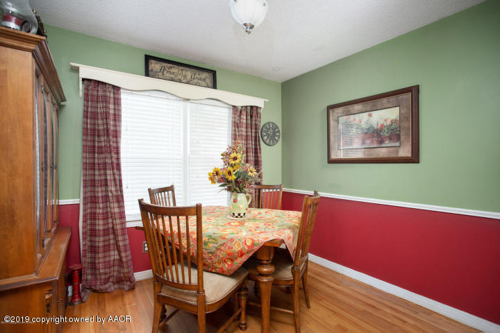 4013 South Travis Street Amarillo, TX 79110 - Photo 15 of 40 a view of a dining room with furniture and wooden floor