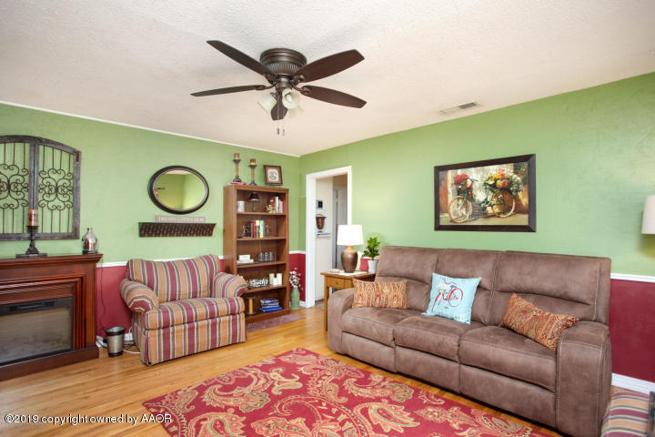 4013 South Travis Street Amarillo, TX 79110 - Photo 3 of 40 a living room with furniture and a large window