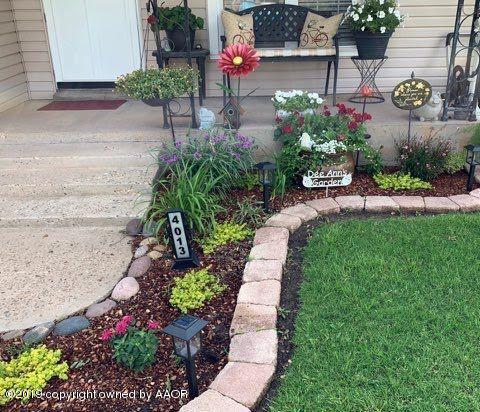 4013 South Travis Street Amarillo, TX 79110 - Photo 26 of 40 a view of garden with wooden bench