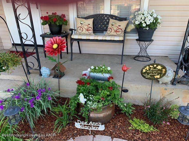 4013 South Travis Street Amarillo, TX 79110 - Photo 29 of 40 a flower garden with wooden benches