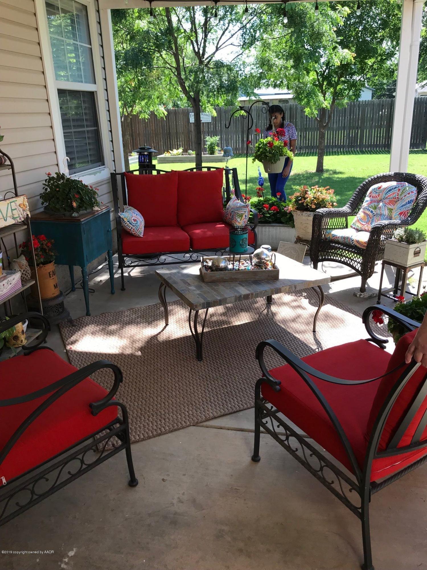 4013 South Travis Street Amarillo, TX 79110 - Photo 30 of 40 a backyard of a house with fire pit and outdoor seating