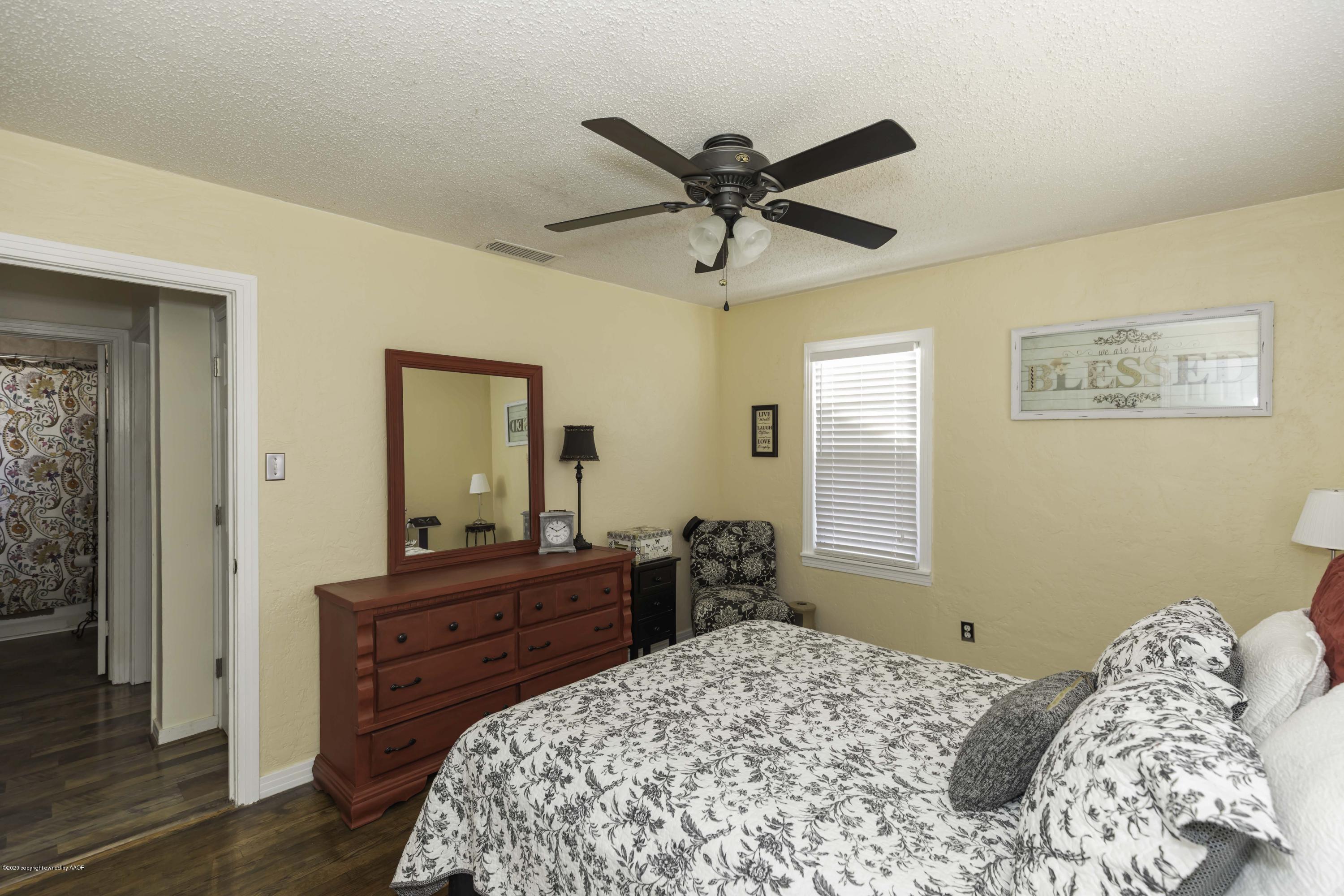 4013 South Travis Street Amarillo, TX 79110 - Photo 32 of 40 a bedroom with a bed and wooden floor