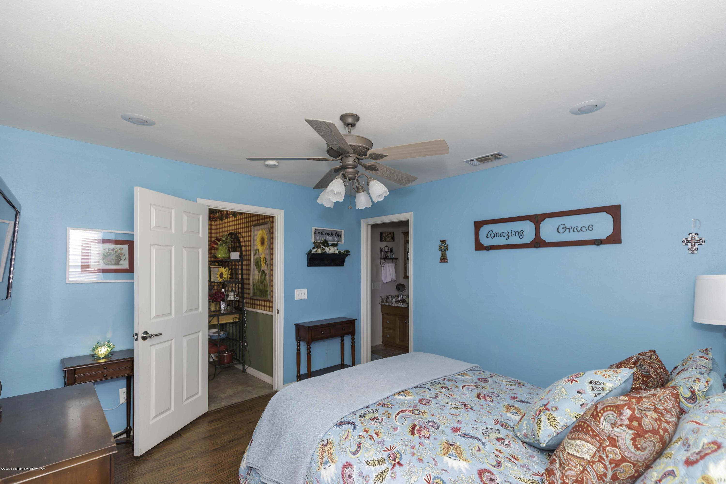 4013 South Travis Street Amarillo, TX 79110 - Photo 38 of 40 a bedroom with a bed and a chandelier