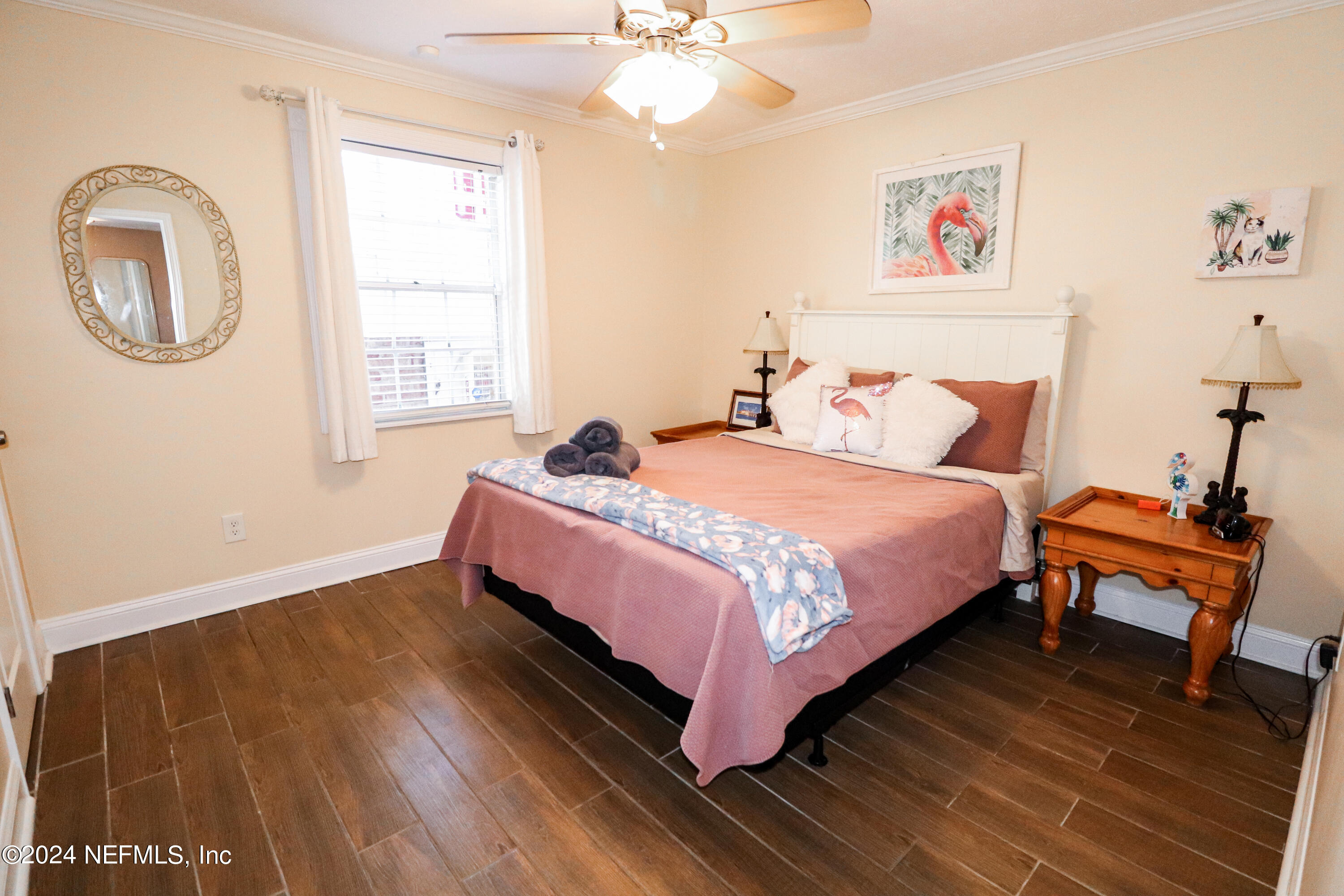 317 Flagler Boulevard, Unit 4A St. Augustine, FL 32080 - Photo 13 of 19 a bedroom with a bed and wooden floor