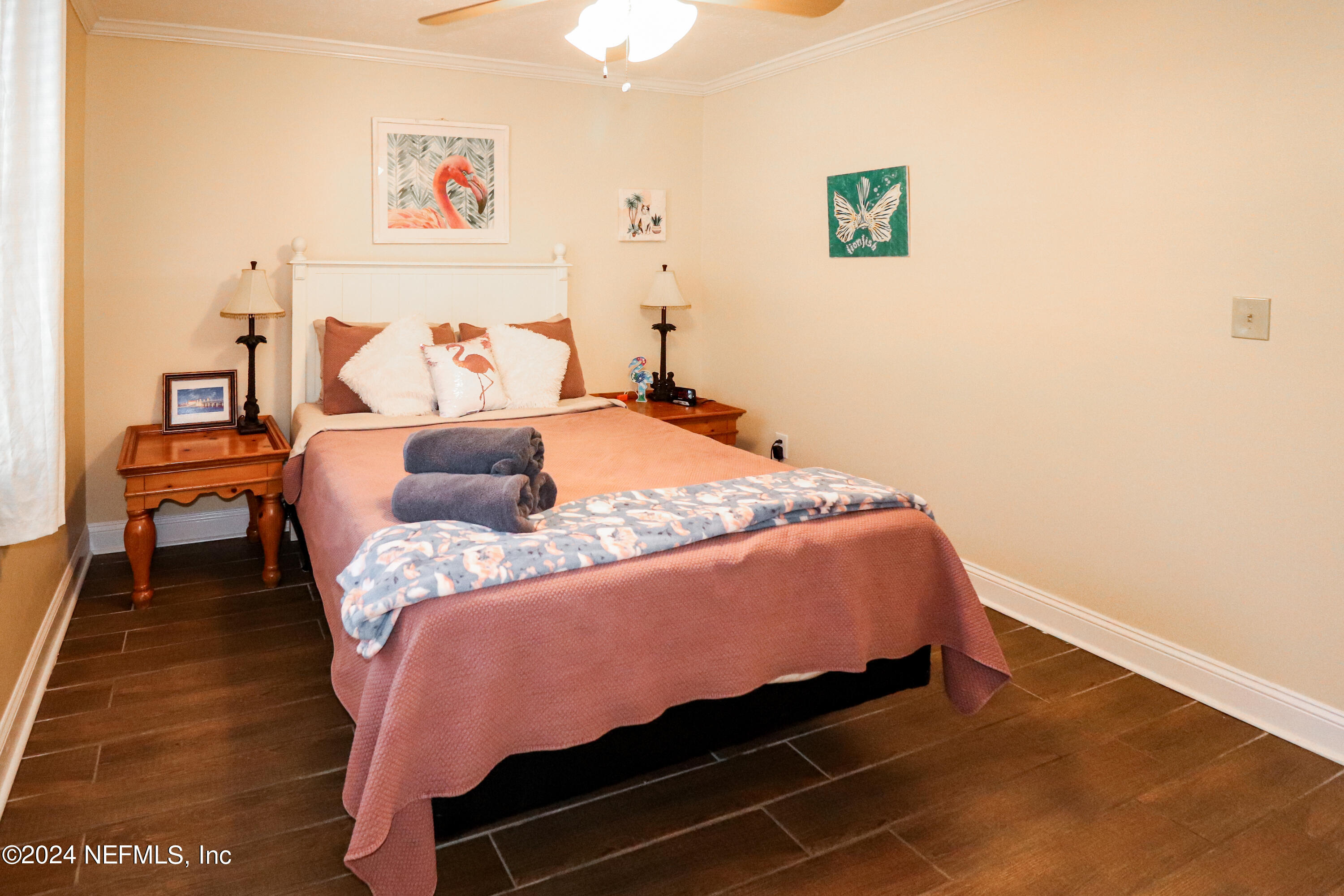 317 Flagler Boulevard, Unit 4A St. Augustine, FL 32080 - Photo 14 of 19 a bed sitting in a bedroom next to a window with a book on a table