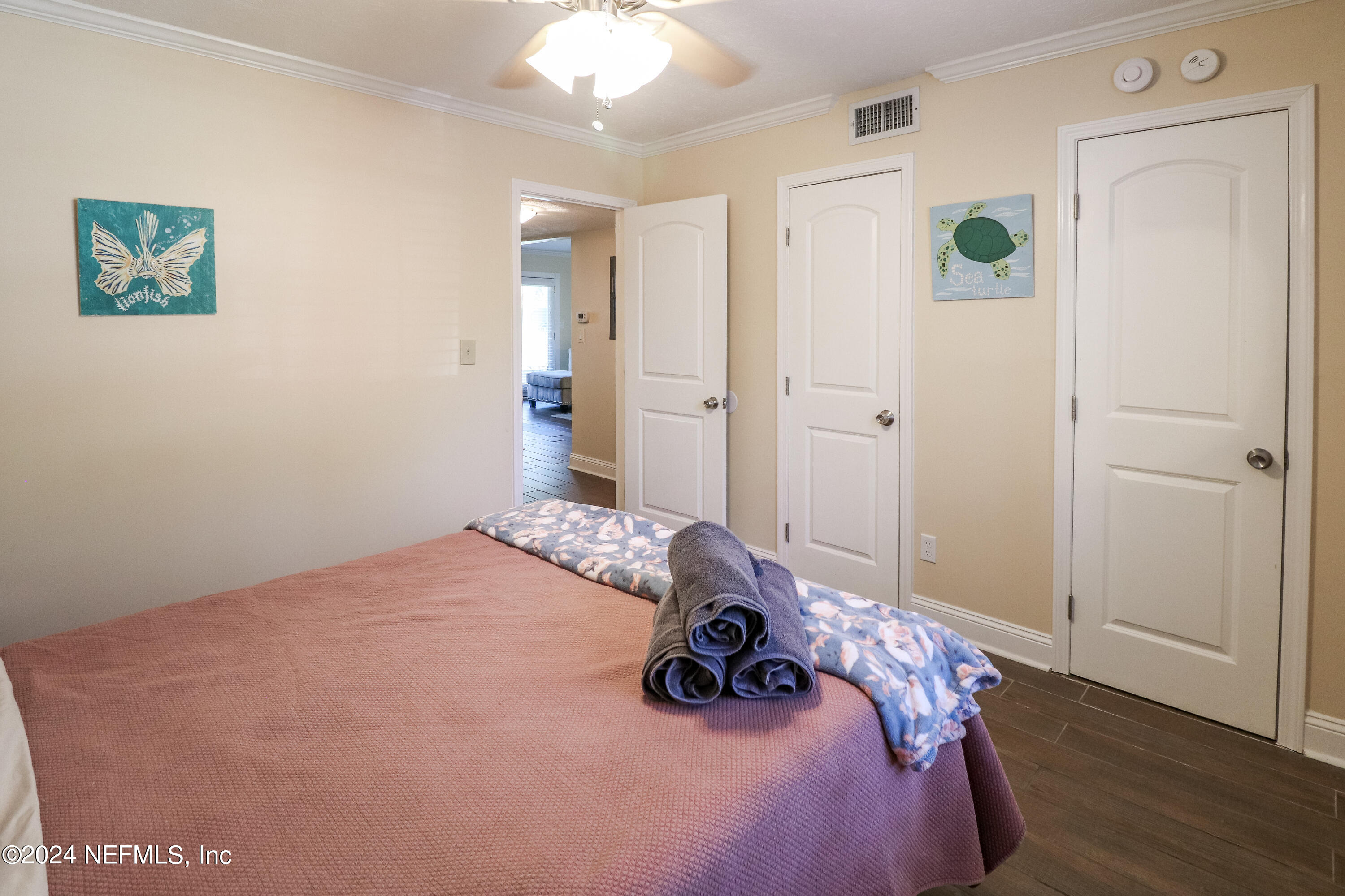 317 Flagler Boulevard, Unit 4A St. Augustine, FL 32080 - Photo 15 of 19 a bedroom with a bed and wooden floor