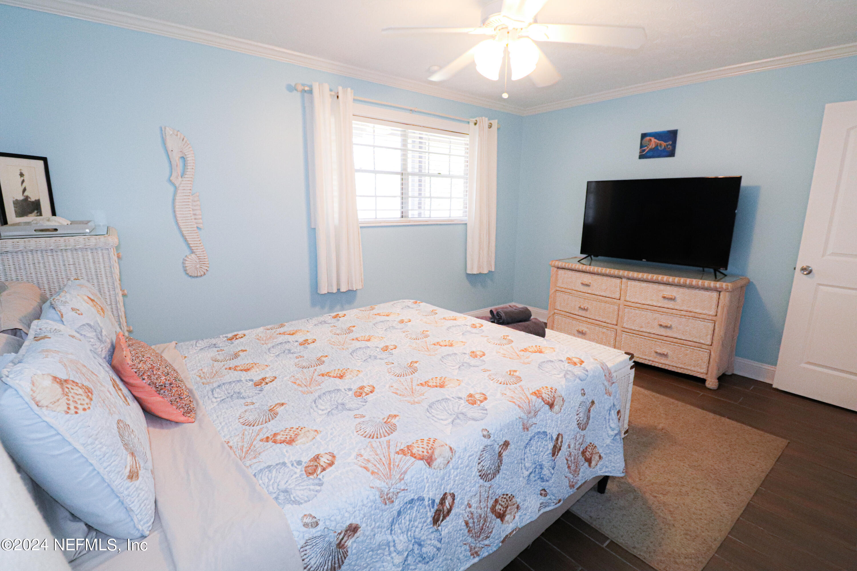 317 Flagler Boulevard, Unit 4A St. Augustine, FL 32080 - Photo 18 of 19 a bedroom with a bed and a flat screen tv
