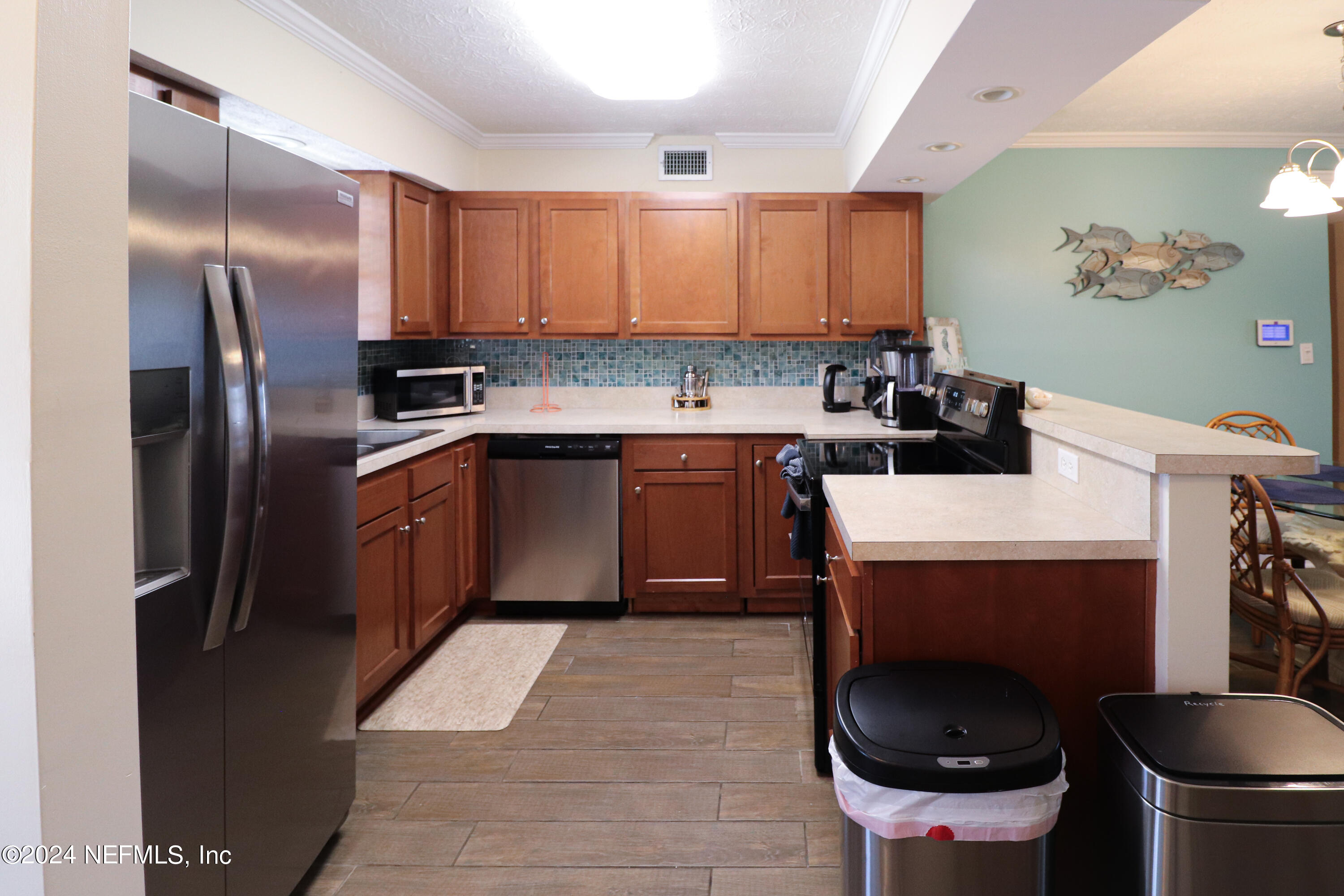 317 Flagler Boulevard, Unit 4A St. Augustine, FL 32080 - Photo 5 of 19 a kitchen with stainless steel appliances granite countertop a sink a stove a refrigerator and cabinets