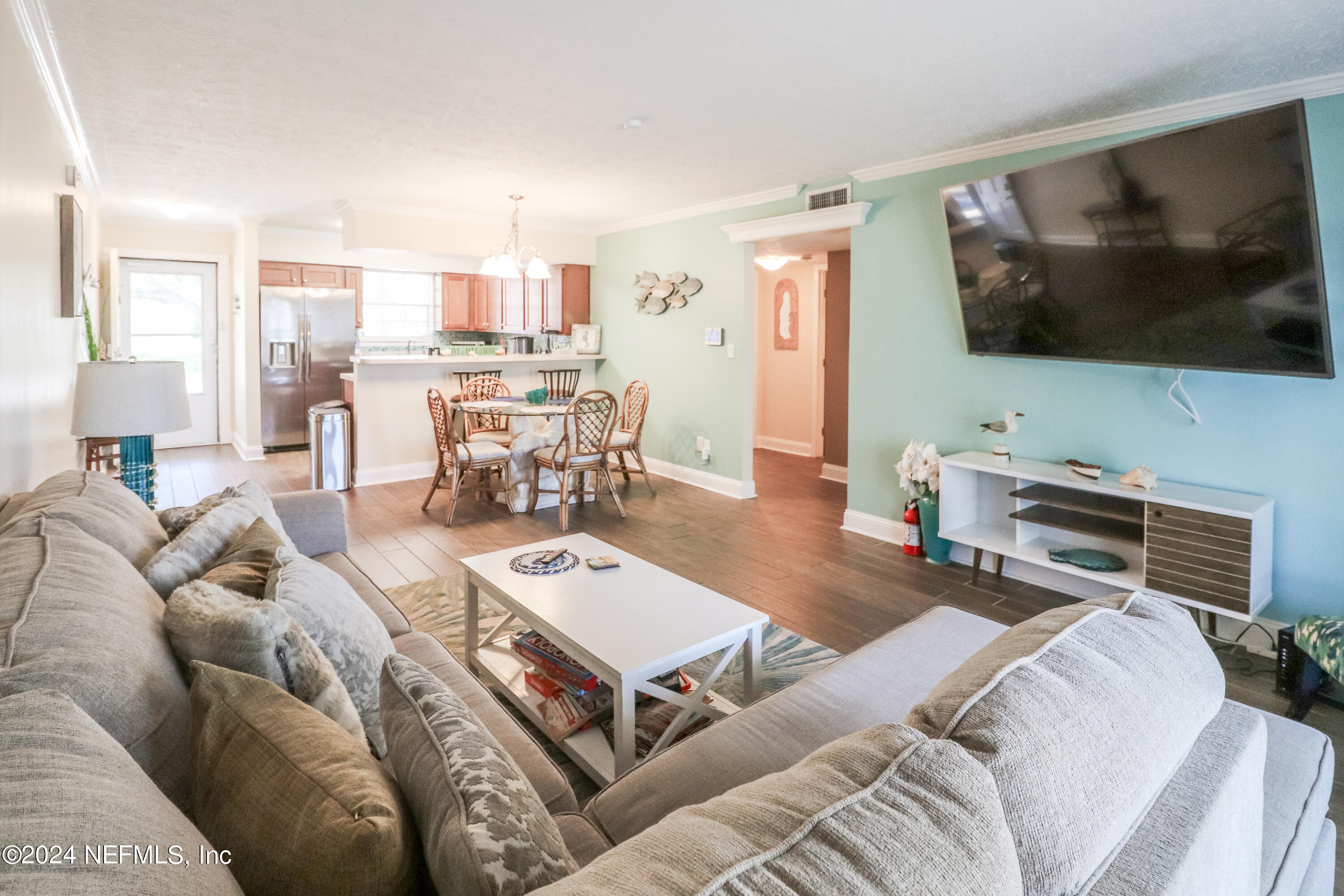 317 Flagler Boulevard, Unit 4A St. Augustine, FL 32080 - Photo 7 of 19 a living room with furniture and a flat screen tv