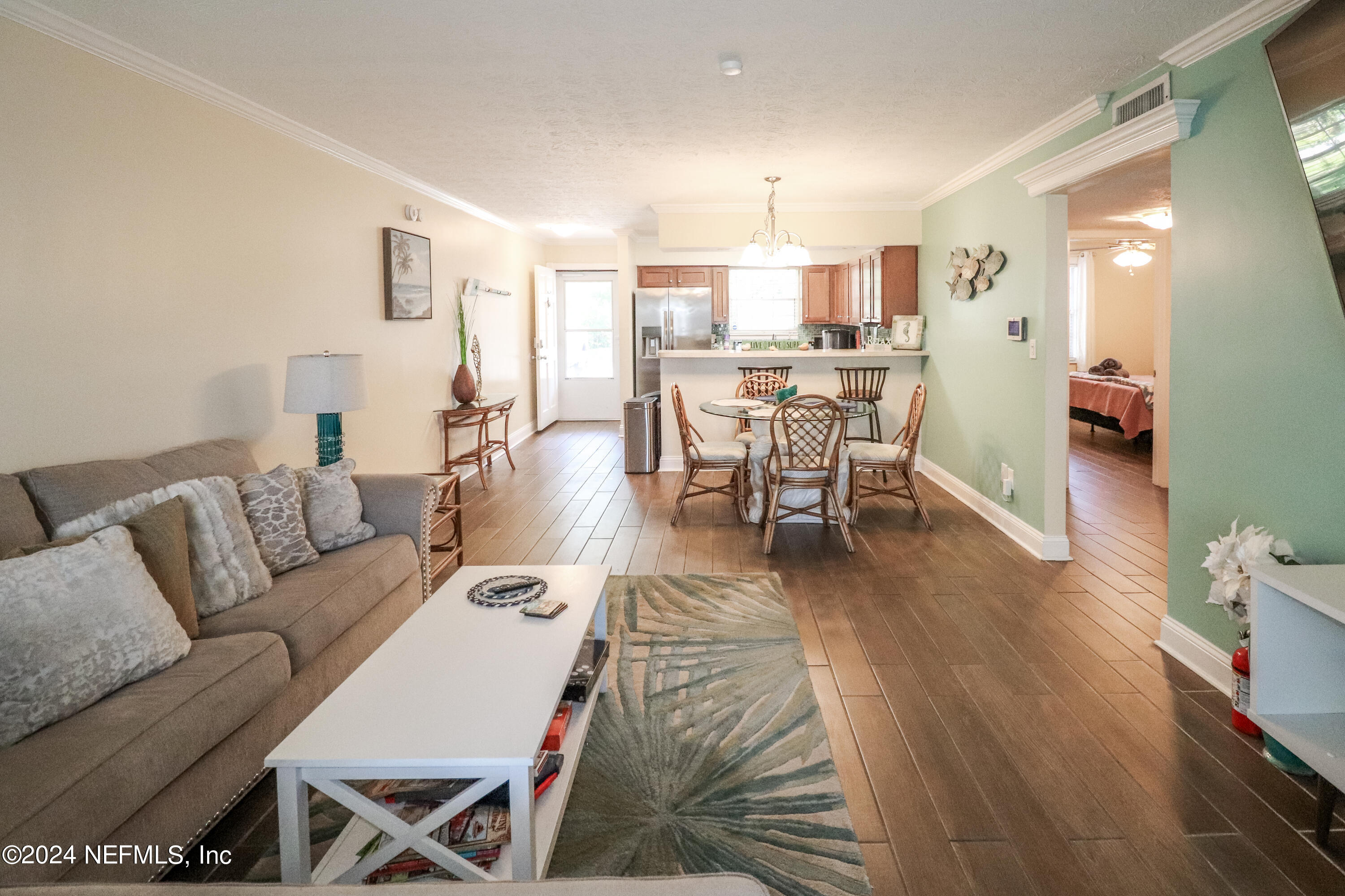 317 Flagler Boulevard, Unit 4A St. Augustine, FL 32080 - Photo 8 of 19 a living room with lots of furniture and kitchen view