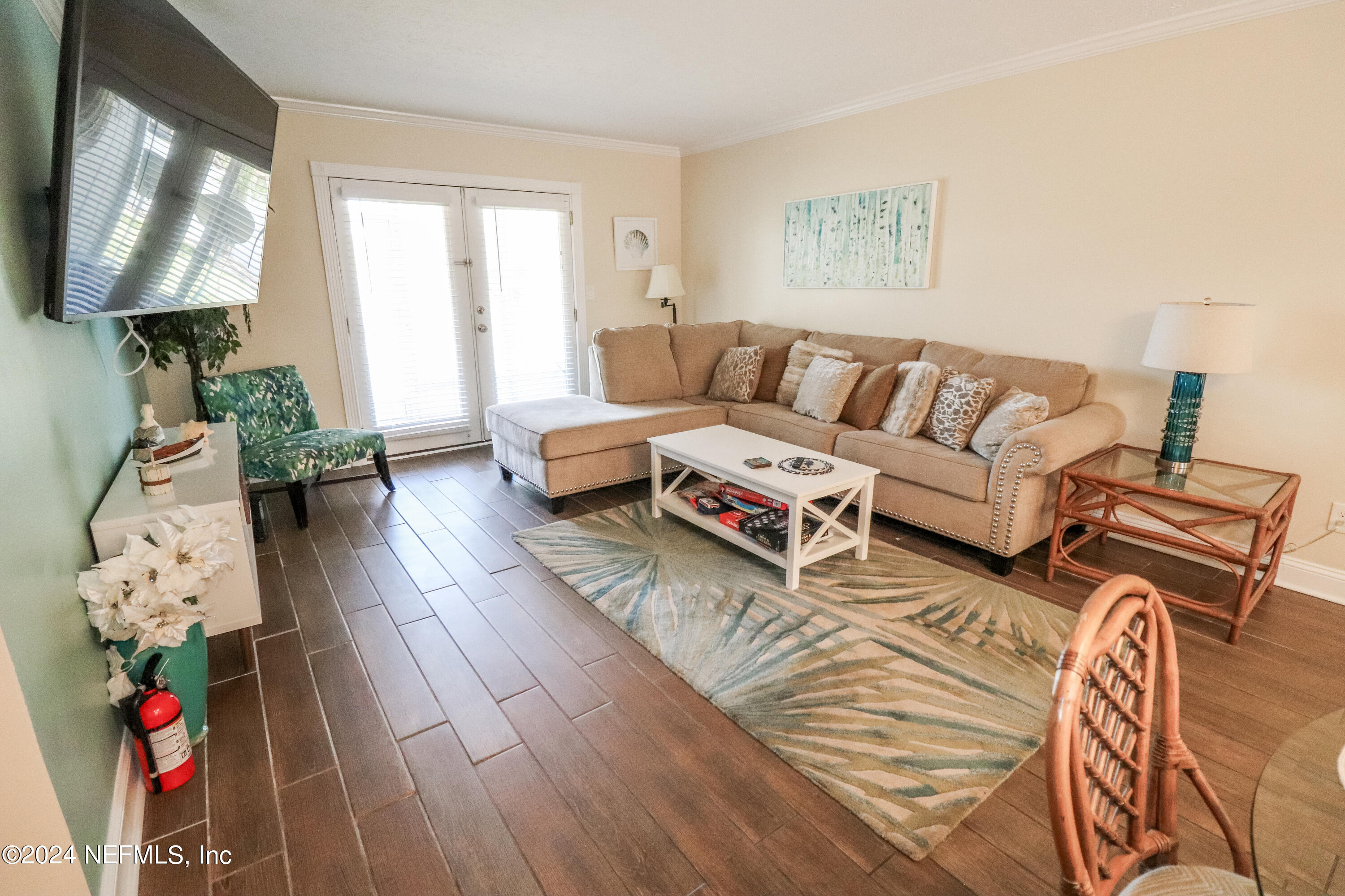 317 Flagler Boulevard, Unit 4A St. Augustine, FL 32080 - Photo 9 of 19 a living room with furniture and a flat screen tv