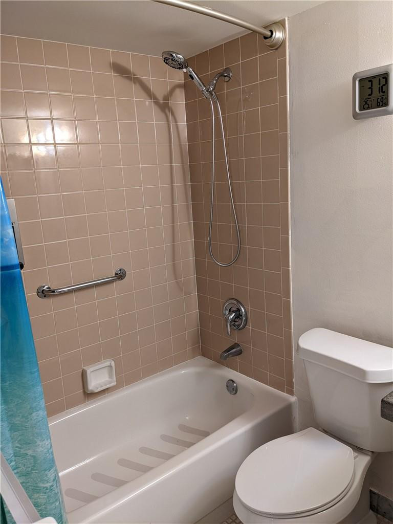 9280 Southwest 3rd Street, Unit 810 Boca Raton, FL 33428 - Photo 12 of 22 a white toilet and tub sitting next to a bathroom sink