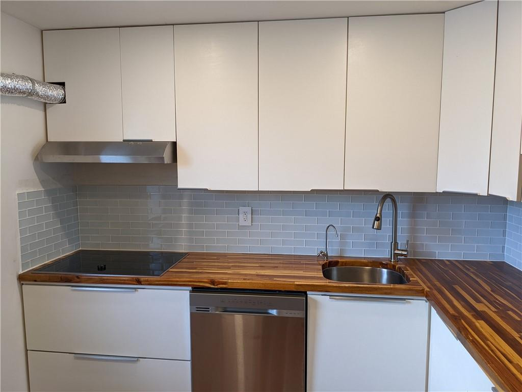9280 Southwest 3rd Street, Unit 810 Boca Raton, FL 33428 - Photo 3 of 22 a kitchen with stainless steel appliances granite countertop a sink and a white cabinets