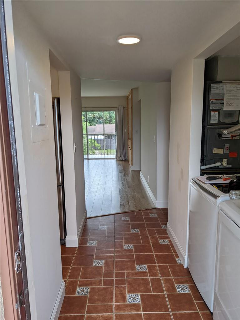 9280 Southwest 3rd Street, Unit 810 Boca Raton, FL 33428 - Photo 5 of 22 a view of a closet area with wooden floor and a window