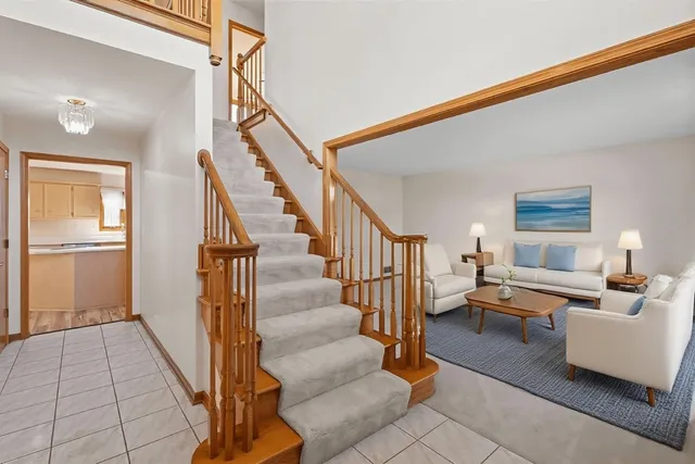 a living room with stairs and furniture