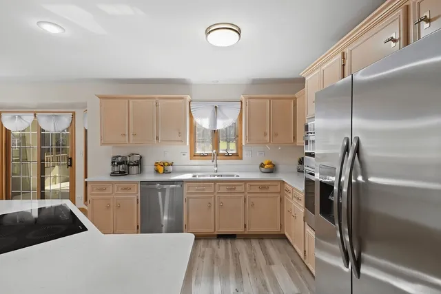 a kitchen with a sink stainless steel appliances and cabinets