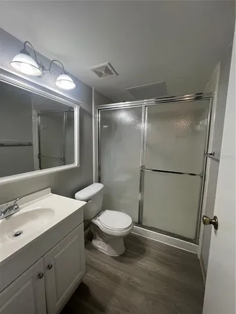 a bathroom with a sink toilet and shower