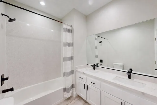 a bathroom with a bathtub and a sink