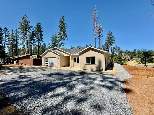 a big house with a big yard and large trees