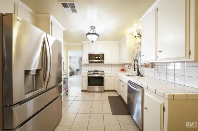 a kitchen with a stove a refrigerator and a sink